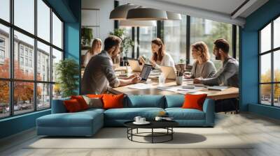 business people or coworkers gathered around a table working Wall mural