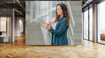 business woman in the street with tablet or ebook Wall mural