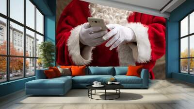 closeup of santa claus hands with mobile phone Wall mural