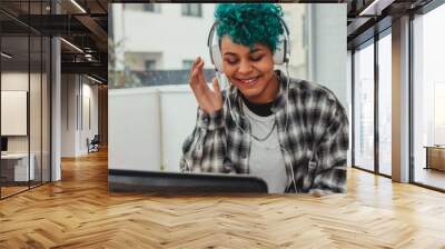 girl with computer and headphones at home or office desk Wall mural