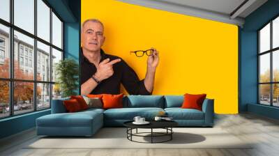 Isolated adult man pointing glasses isolated on background Wall mural