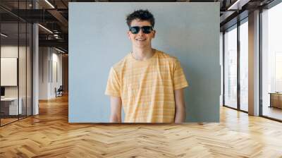 isolated teen boy with sunglasses Wall mural