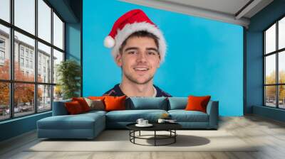 isolated young man portrait with santa claus hat Wall mural