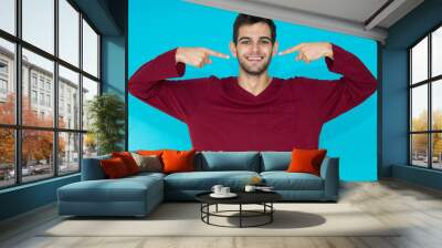 isolated young man with approval expression in color background Wall mural