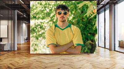 portrait of smiling young man in sunglasses and yellow t-shirt in summer Wall mural