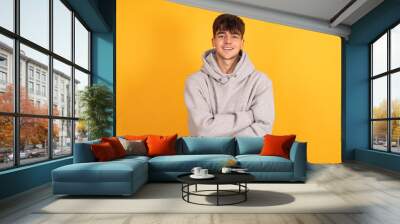 portrait of teen boy isolated on yellow background Wall mural