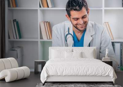 portrait of young doctor working with device Wall mural