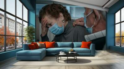 senior couple wearing masks with coronavirus symptoms Wall mural