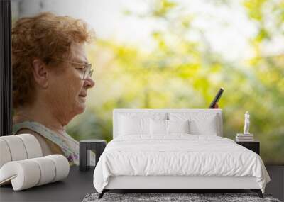 senior woman with mobile phone Wall mural