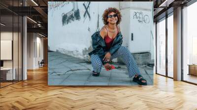 young afro american girl in urban style in summer on the city street Wall mural