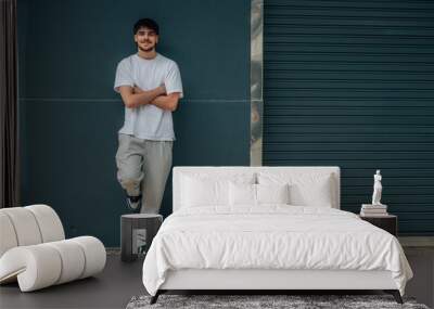 young man in the street leaning on the wall Wall mural