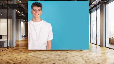 young man isolated on color background Wall mural