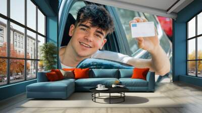 young nobel in the car with driver's license Wall mural