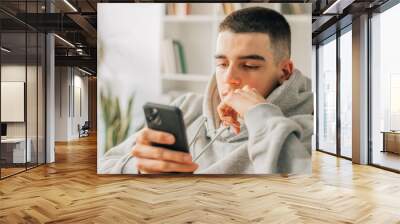 young teenager at home looking at mobile phone Wall mural