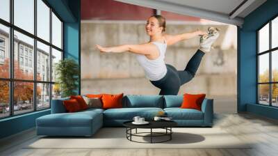 young woman training or doing sports outdoors, skater Wall mural