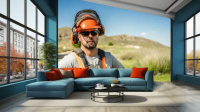 Portrait of a workerman wearing protective gear looking at the camera. Wall mural