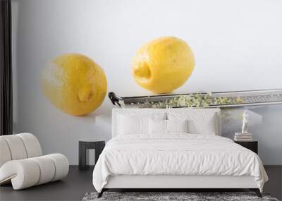 Lemon zest with a microplane and two lemons in behind. Wall mural