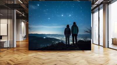 Two hikers in silhouette standing on a hill looking at the bright starry evening sky. Lovely evening night sky landscape image. Generative AI. 
 Wall mural