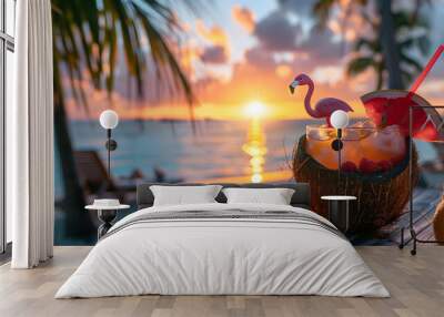 Coconut cocktail and tropical flowers with a flamingo parasol in front of the sea, at sunset, summer concept vacation concept holidays Wall mural