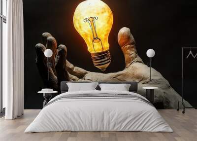 Sculpted hand holding an illuminated lightbulb in dark background Wall mural