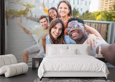 happy Multiracial group of friends making a selfie with phone in the university, focus on the girl - friendship, happiness and joyful concept Wall mural