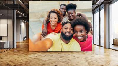 Multiracial friends taking selfie shot smiling at camera - Laughing young people standing outdoor and having fun sitting on stairs - Cheerful students portrait outside school Wall mural