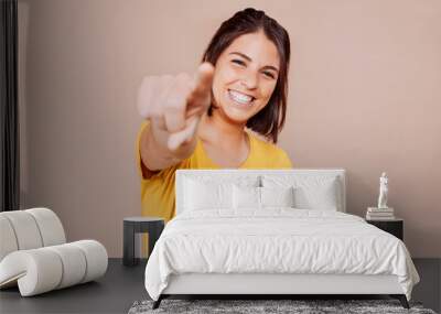 Smiling woman point finger at you, positive mood. Wall mural