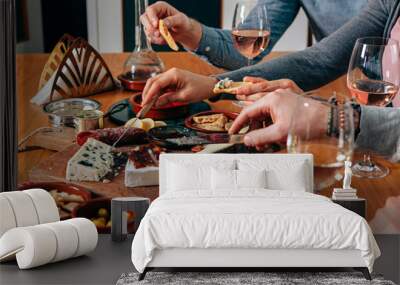 hands picking up and cutting delicattessen from a table prepared with gourmet finger food Wall mural