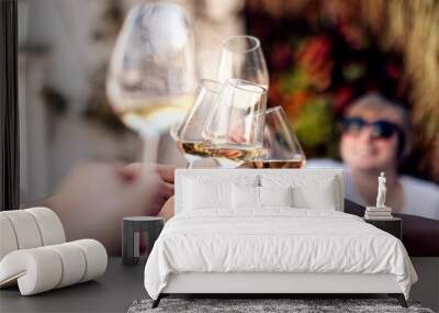 toast with white wine. multiracial people clinking glasses with wine on terrace, cafe, restaurant, party. Wall mural