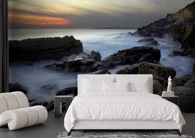 Dramatic coastline with the ocean in motion in the evening. Wall mural