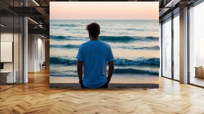 A person with their back turned, wearing casual clothes, looking out at a vast and tranquil ocean. Generative AI Wall mural