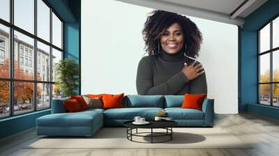 Beautiful mid aged black African American Smiling Woman with curly hair Wearing a Green sweater with arms crossed  Wall mural