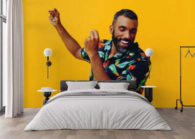 close up handsome bearded mid adult african american man smiling and dancing wearing Hawaiian shirt on vacation studio shot Wall mural