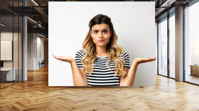 confused young woman making scale balance with hands, decision making  Wall mural