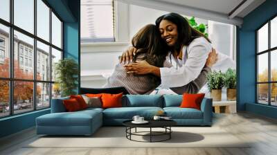 Female doctor hugging young woman in surgery Wall mural