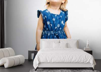 Full body portrait of a cute little preschool girl looking up on white background Wall mural