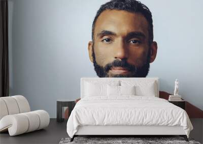 headshot portrait of a handsome thoughtful bearded mid adult man looking at camera against gray background studio shot Wall mural