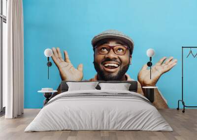 It's incredible! Portrait of a happy and excited man looking up with mouth open and both arms up Wall mural