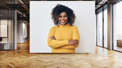 Portrait of a beautiful black woman smiling with arms crossed Wall mural