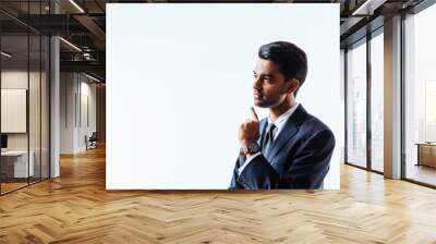 Portrait of a businessman thinking with finger near chin  and looking to side, isolated on white studio background.. Wall mural