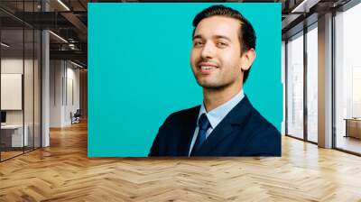 Portrait of a confident, smiling man in suit and tie, isolated on blue studio background Wall mural