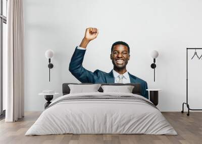 Portrait of a happy young man in business suit with fist  up, isolated on white studio background Wall mural