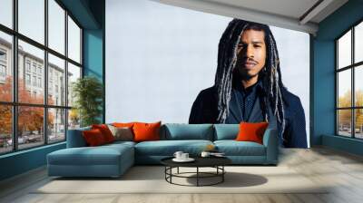 Portrait of a serious young man with cool dreadlocks hair isolated in studio Wall mural