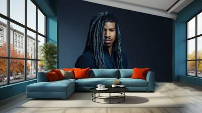 Portrait of a  serious young man with cool hair  and cool black and gray hair in studio Wall mural