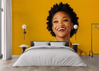 Portrait of a very happy and excited young woman smiling and looking up in an elegant floral top Wall mural