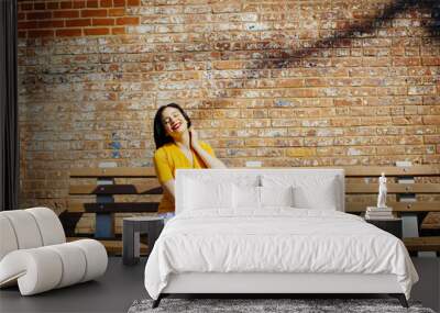 Portrait of a young woman sunbathing in the park enjoying the sun with eyes closed Wall mural