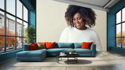 Smiling Woman With curly hair Highlights Looking Down Wall mural