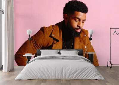 Stylish, handsome and cool African American man with beard, isolated on pink studio background Wall mural