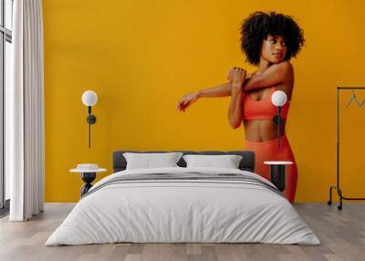 young fit black woman in sportswear posing isolated on yellow background Wall mural