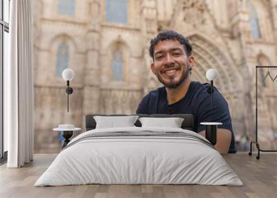 Happy Colombian boy on vacation in the cathedral of Barcelona (Spain) Wall mural